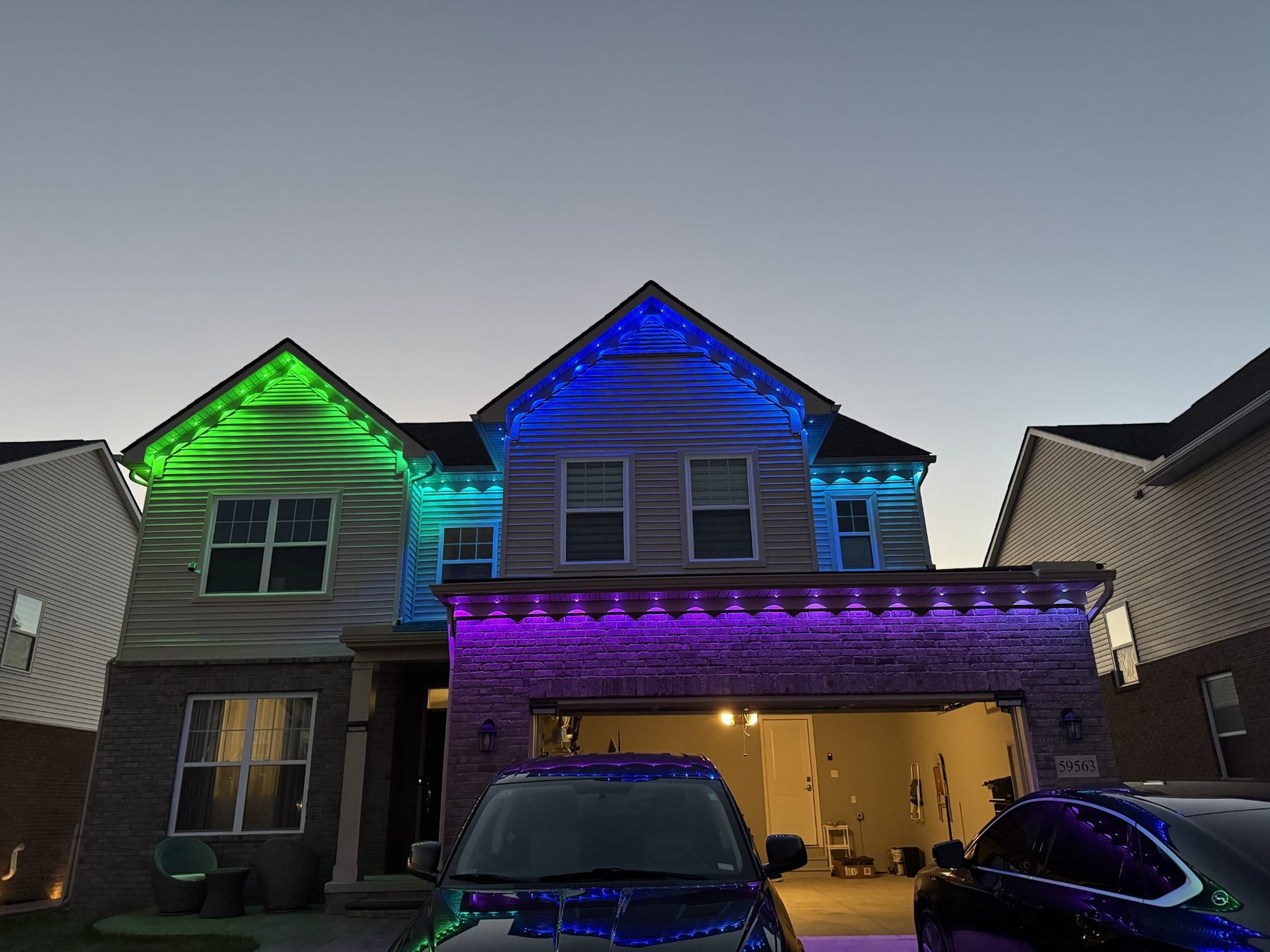 Two-story home with colorful permanent roofline lighting